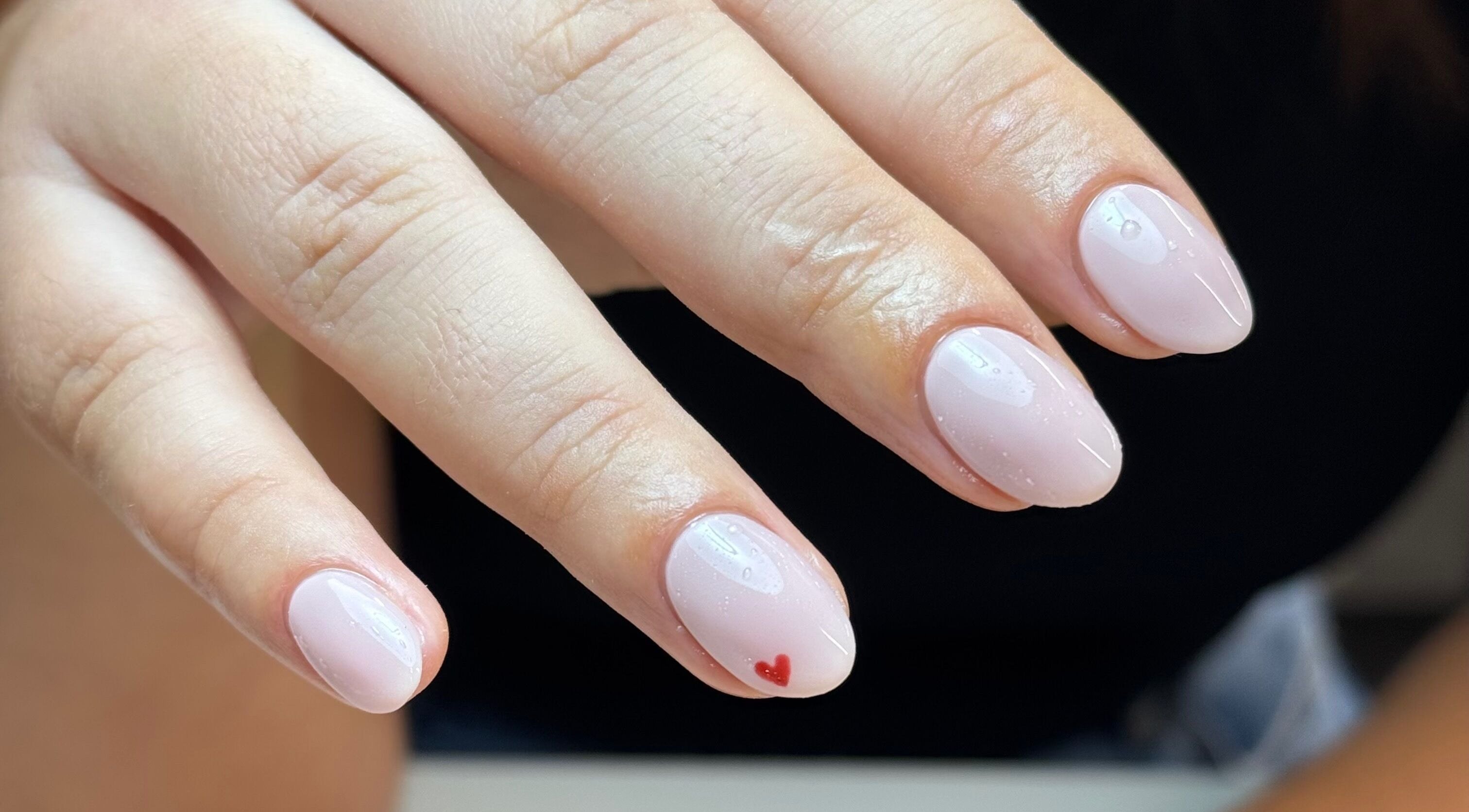 Soft pink manicure with heart design at Morgan Sophie Nails, Colchester, England, GB.