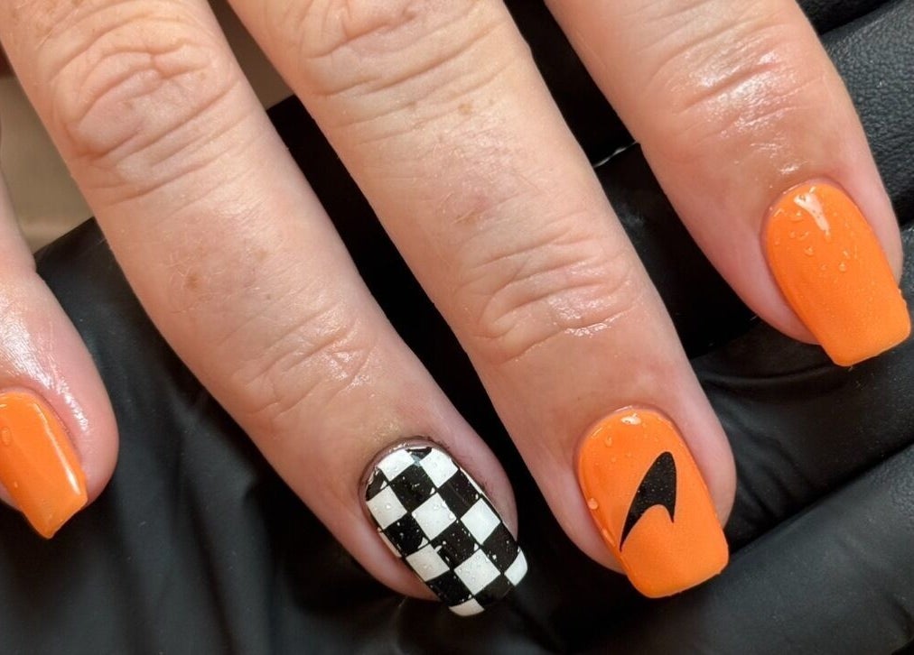 Elegant orange and checkered nail art at Morgan Sophie Nails, Colchester, England, GB.