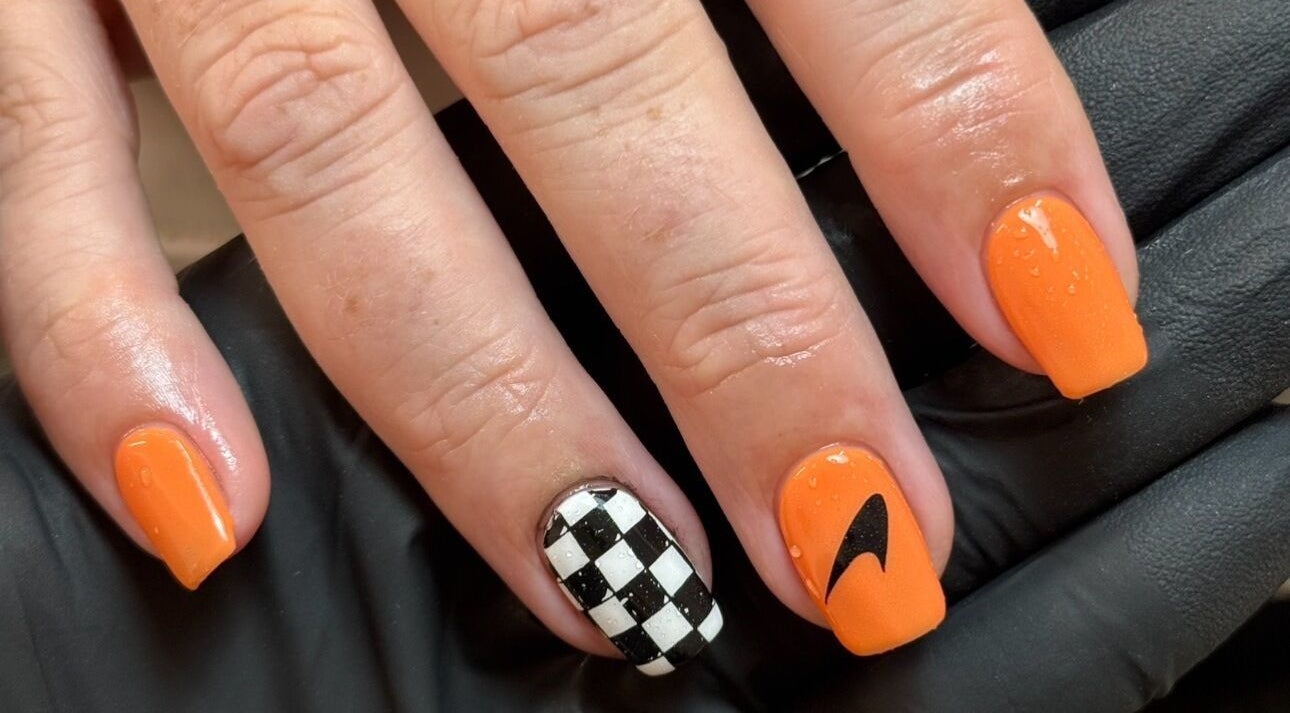Elegant orange and checkered nail art at Morgan Sophie Nails, Colchester, England, GB.