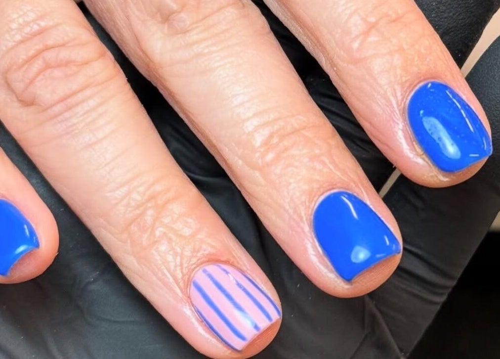 Bright blue and striped nails at Morgan Sophie Nails, Colchester, England, GB.