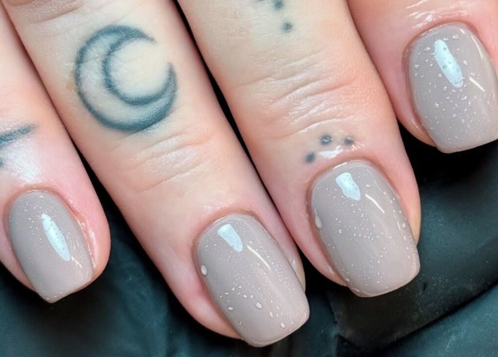Glossy nude manicure with tattoos at Morgan Sophie Nails, Colchester, England, GB.