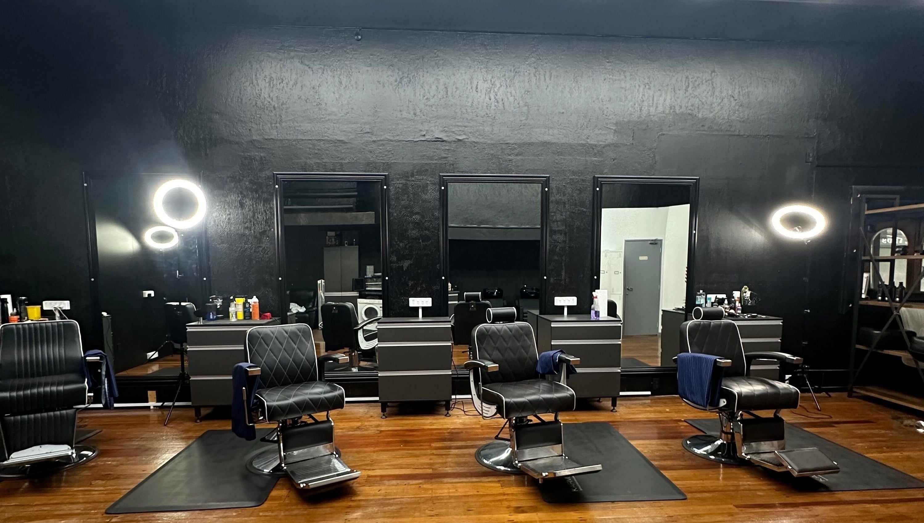 Modern interior of Only Fades Barbershop Inv, Invercargill, Southland, NZ with stylish chairs and mirrors.