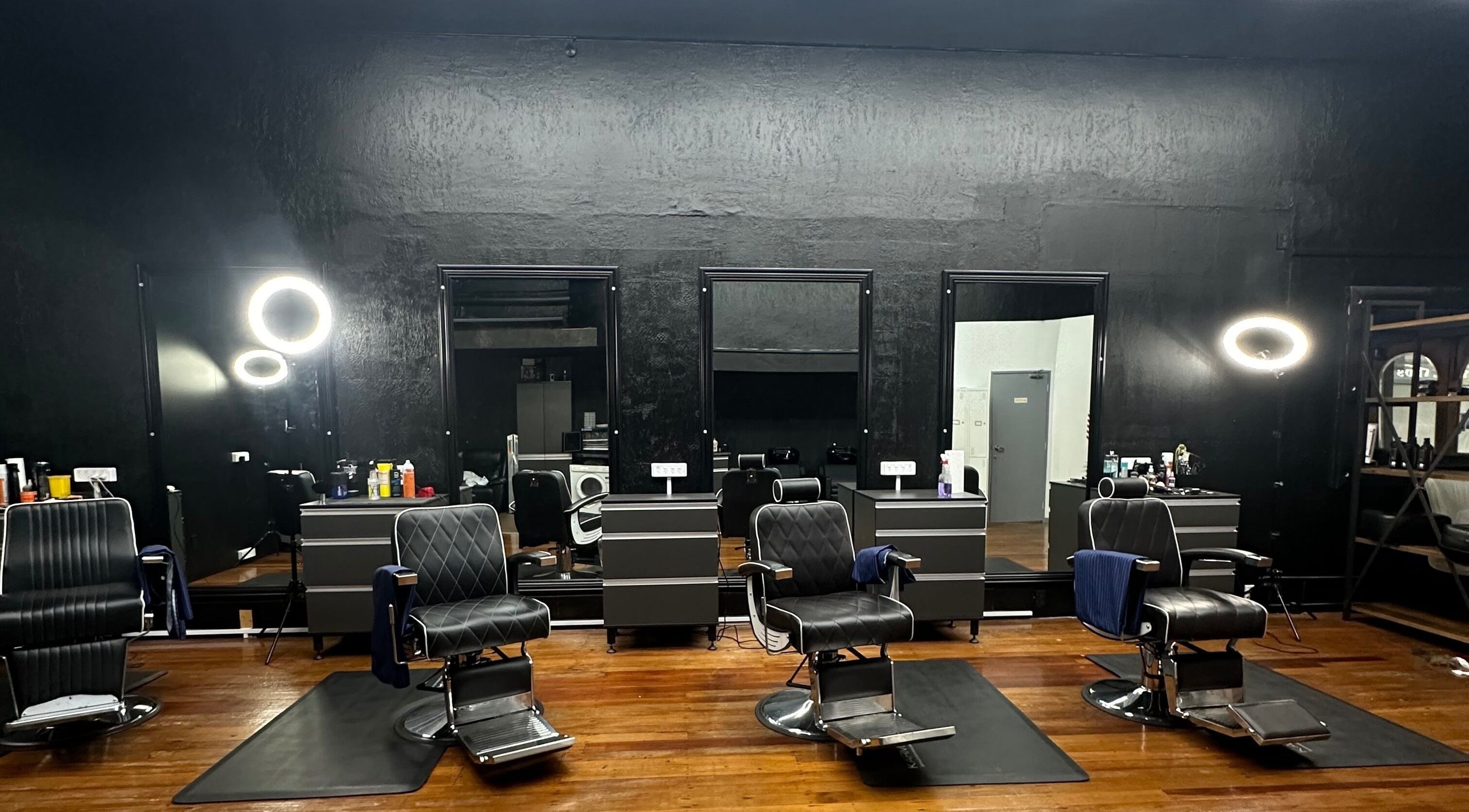 Modern interior of Only Fades Barbershop Inv, Invercargill, Southland, NZ with stylish chairs and mirrors.