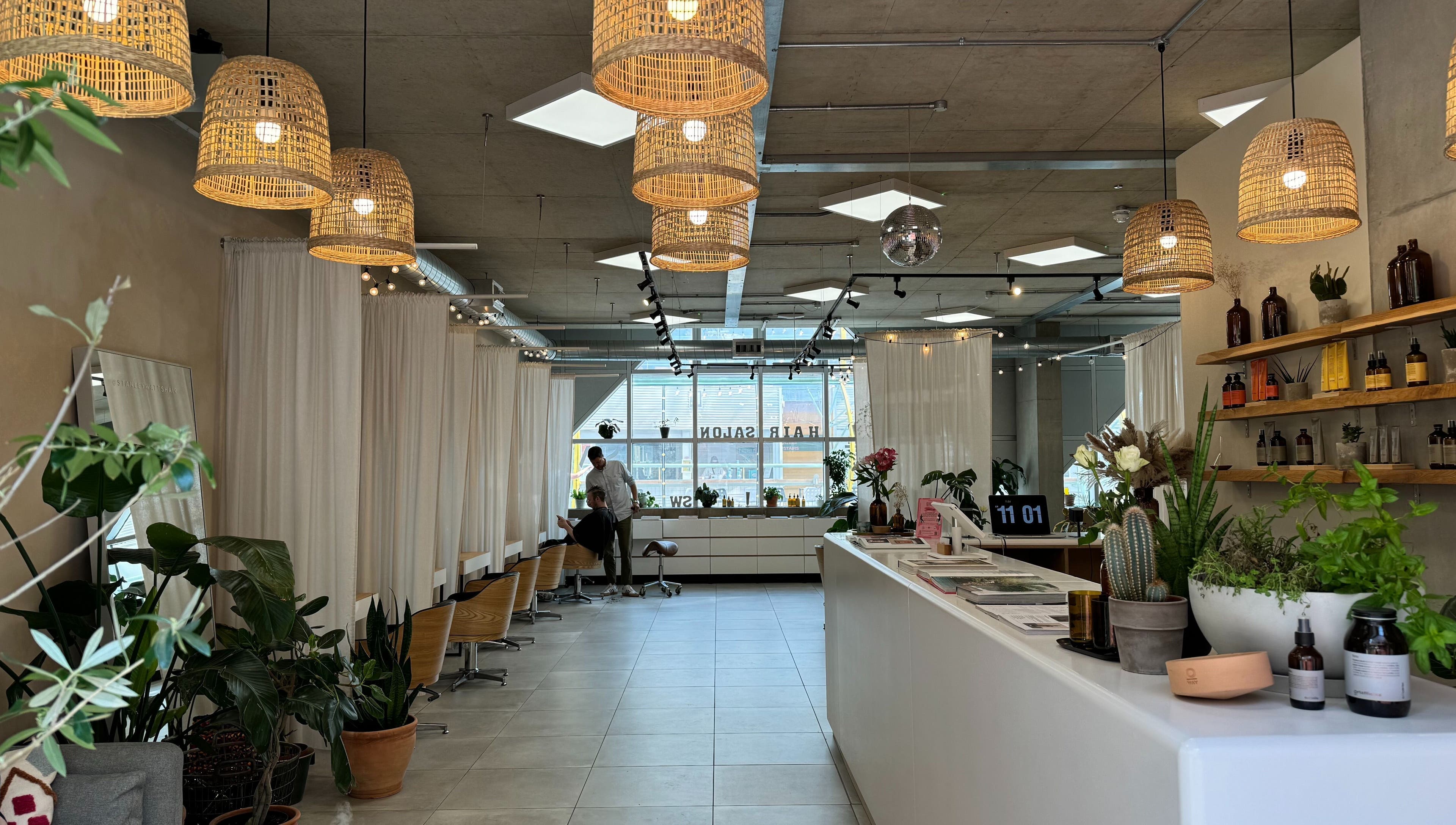 Calm interior of Stanley Watts beauty salon in London, England, GB, featuring modern decor with plants and natural lighting.