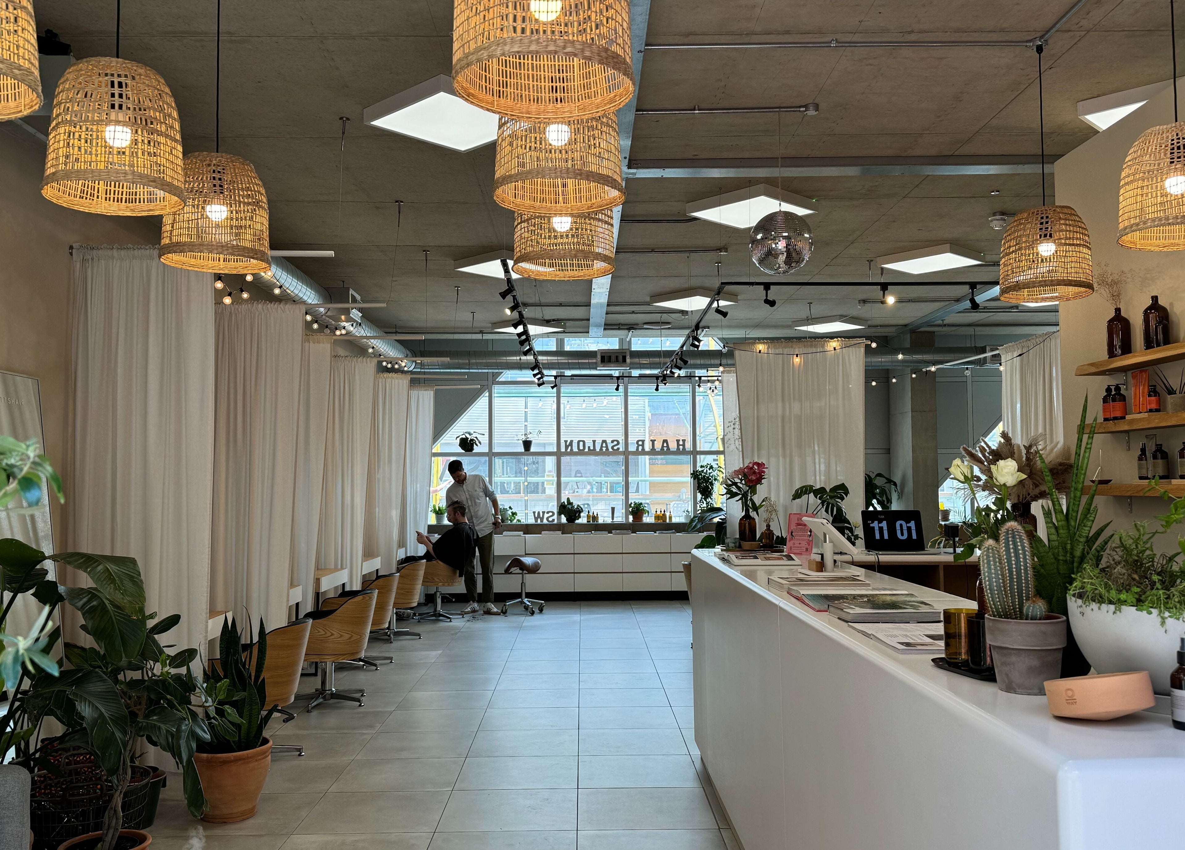 Calm interior of Stanley Watts beauty salon in London, England, GB, featuring modern decor with plants and natural lighting.