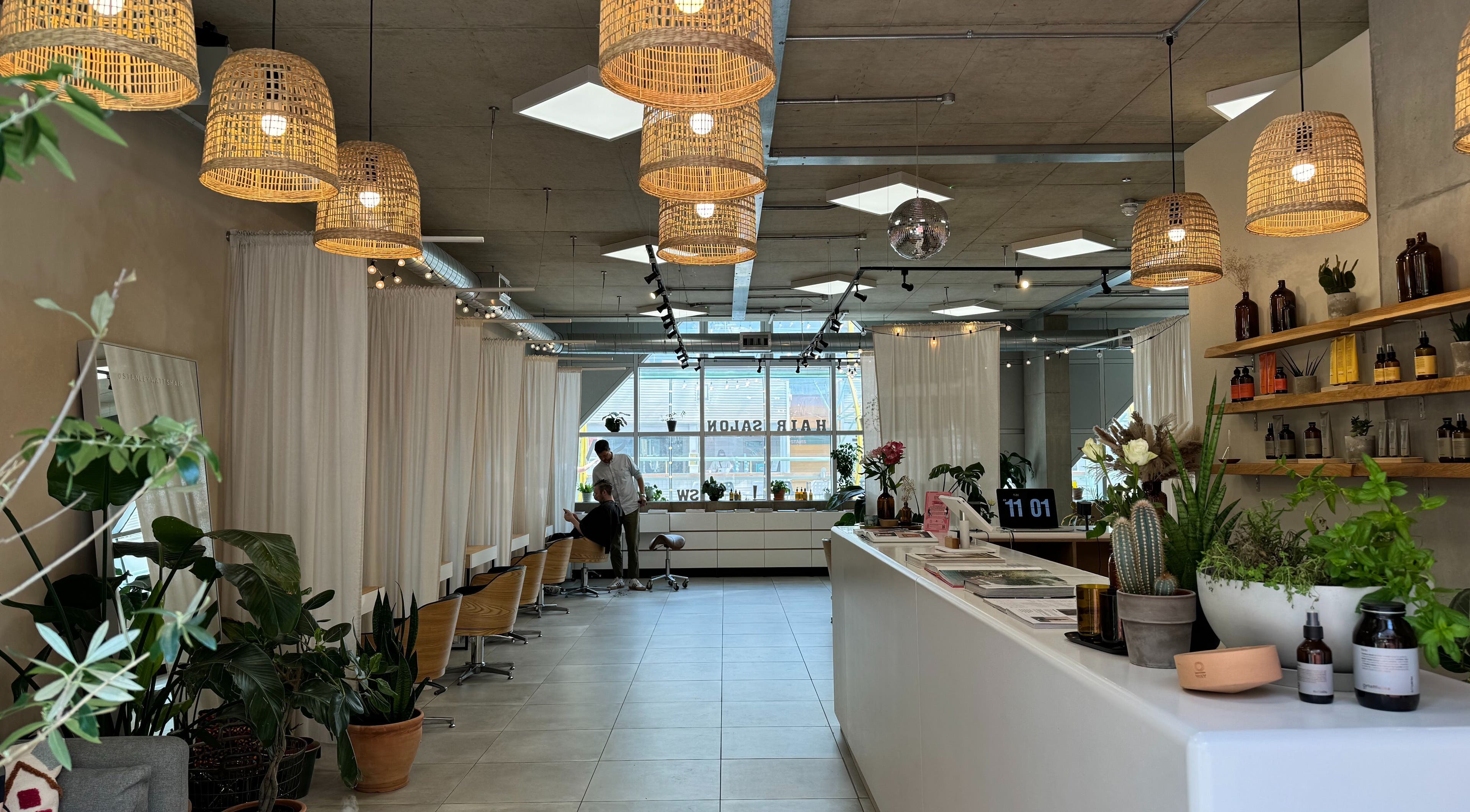 Calm interior of Stanley Watts beauty salon in London, England, GB, featuring modern decor with plants and natural lighting.
