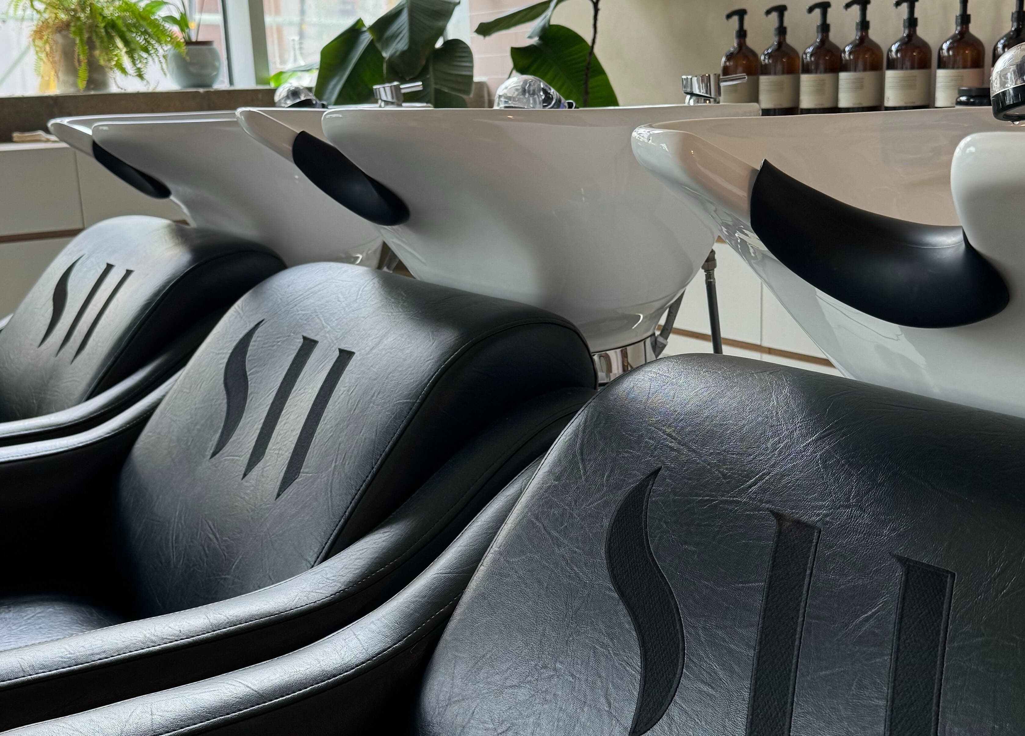 Luxurious shampoo chairs at Stanley Watts salon in London, England, GB with modern design and quality products.