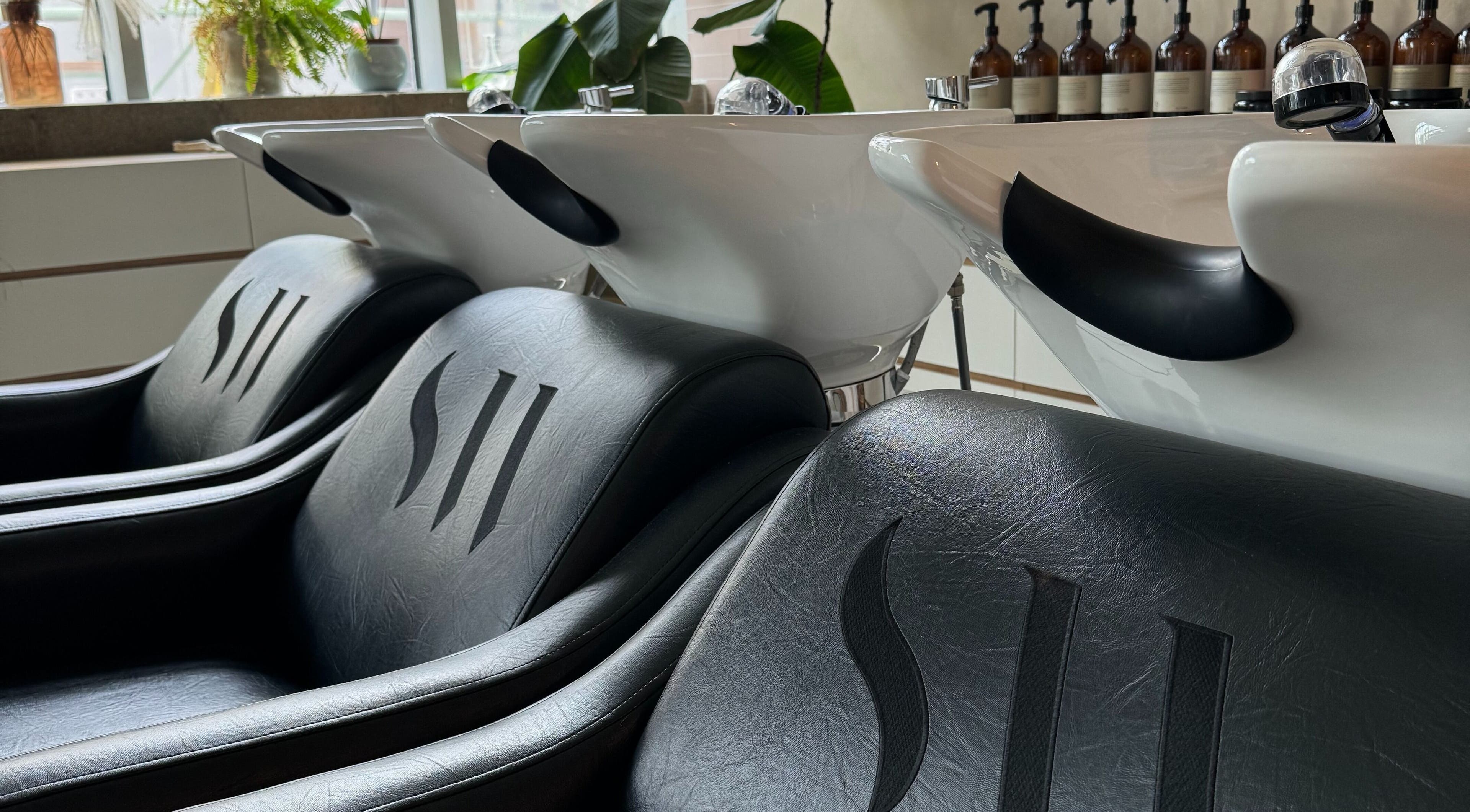 Luxurious shampoo chairs at Stanley Watts salon in London, England, GB with modern design and quality products.