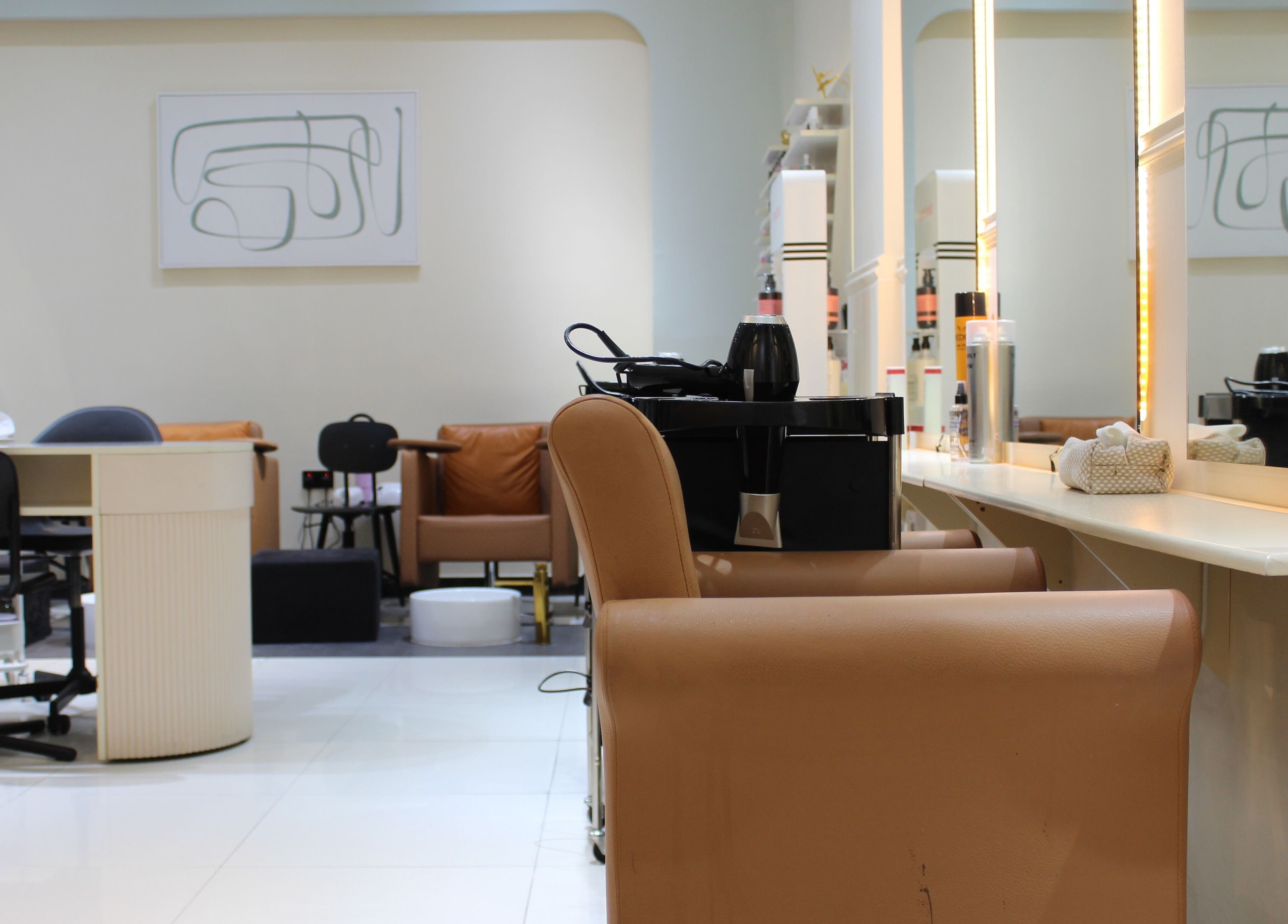 Modern interior of Vivant Beauty Salon in Dubai, Dubai, AE showcasing stylish chairs and bright lighting.