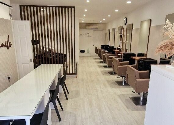 Elegant interior of Tress and Bloom Neath, Neath, Wales, GB, featuring modern chairs and wooden decor.