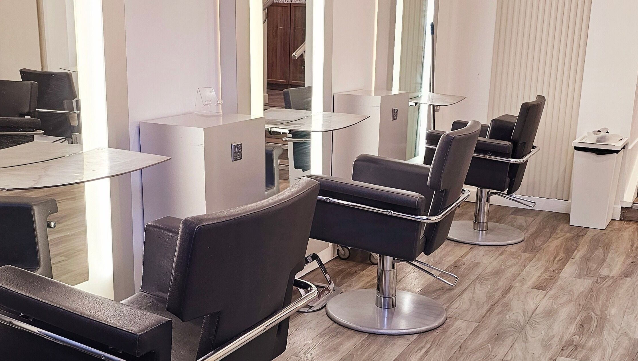 Modern salon chairs at Tress and Bloom Ystradgynlais in Ystradgynlais, Wales, GB, reflecting sleek decor.