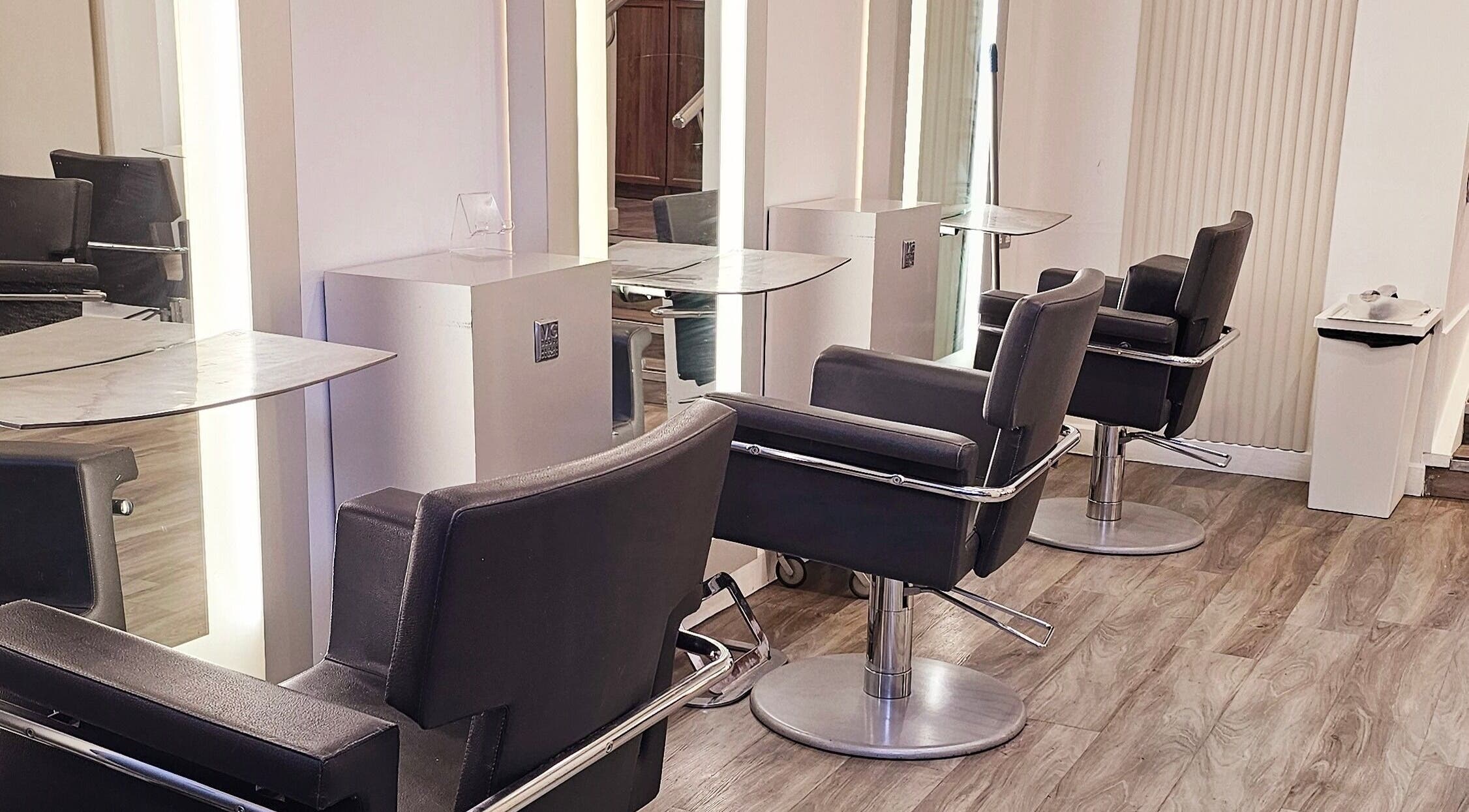 Modern salon chairs at Tress and Bloom Ystradgynlais in Ystradgynlais, Wales, GB, reflecting sleek decor.