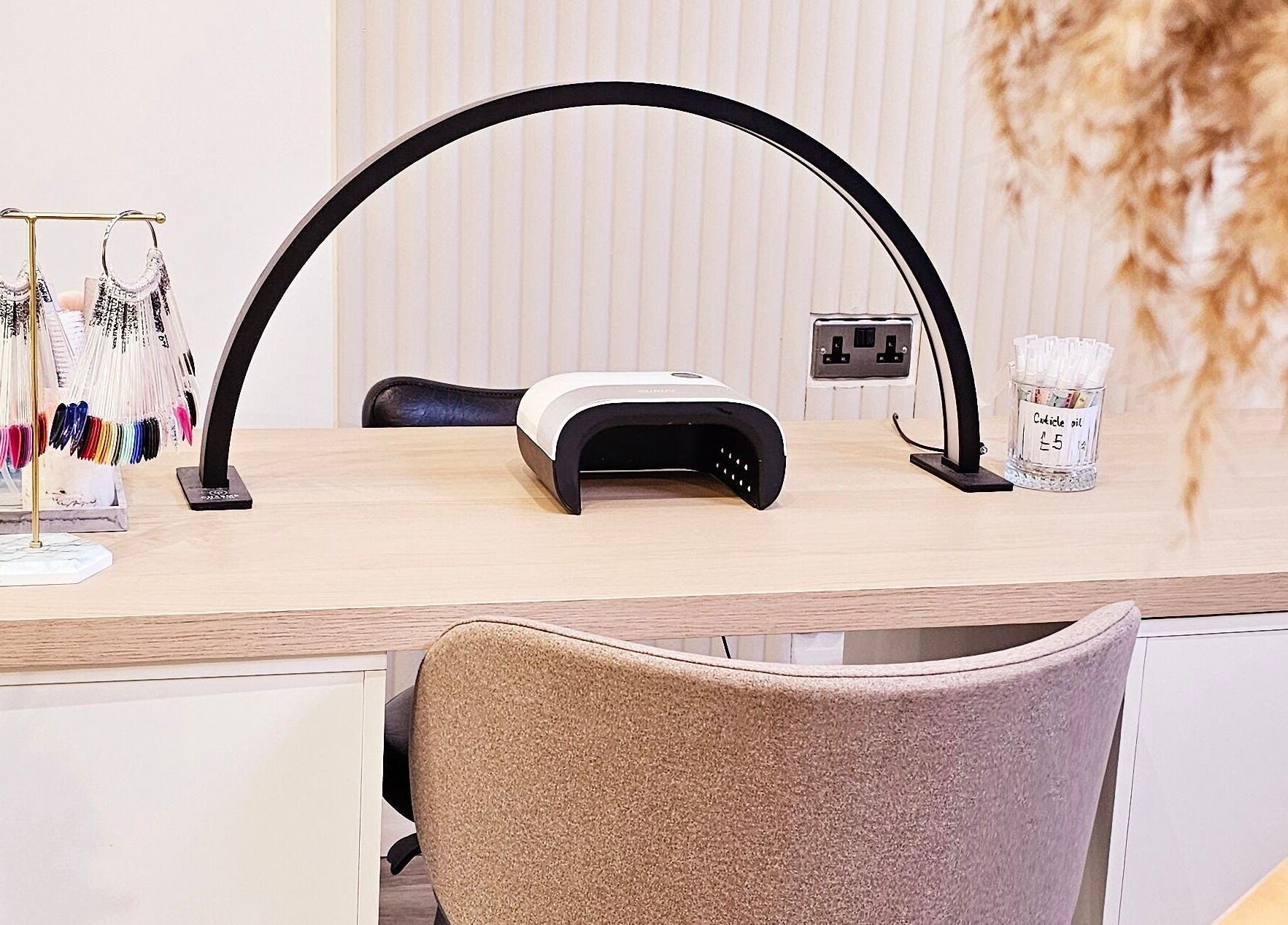 Manicure station at Tress and Bloom Ystradgynlais, Ystradgynlais, Wales, GB, featuring nail polish shades and tools.