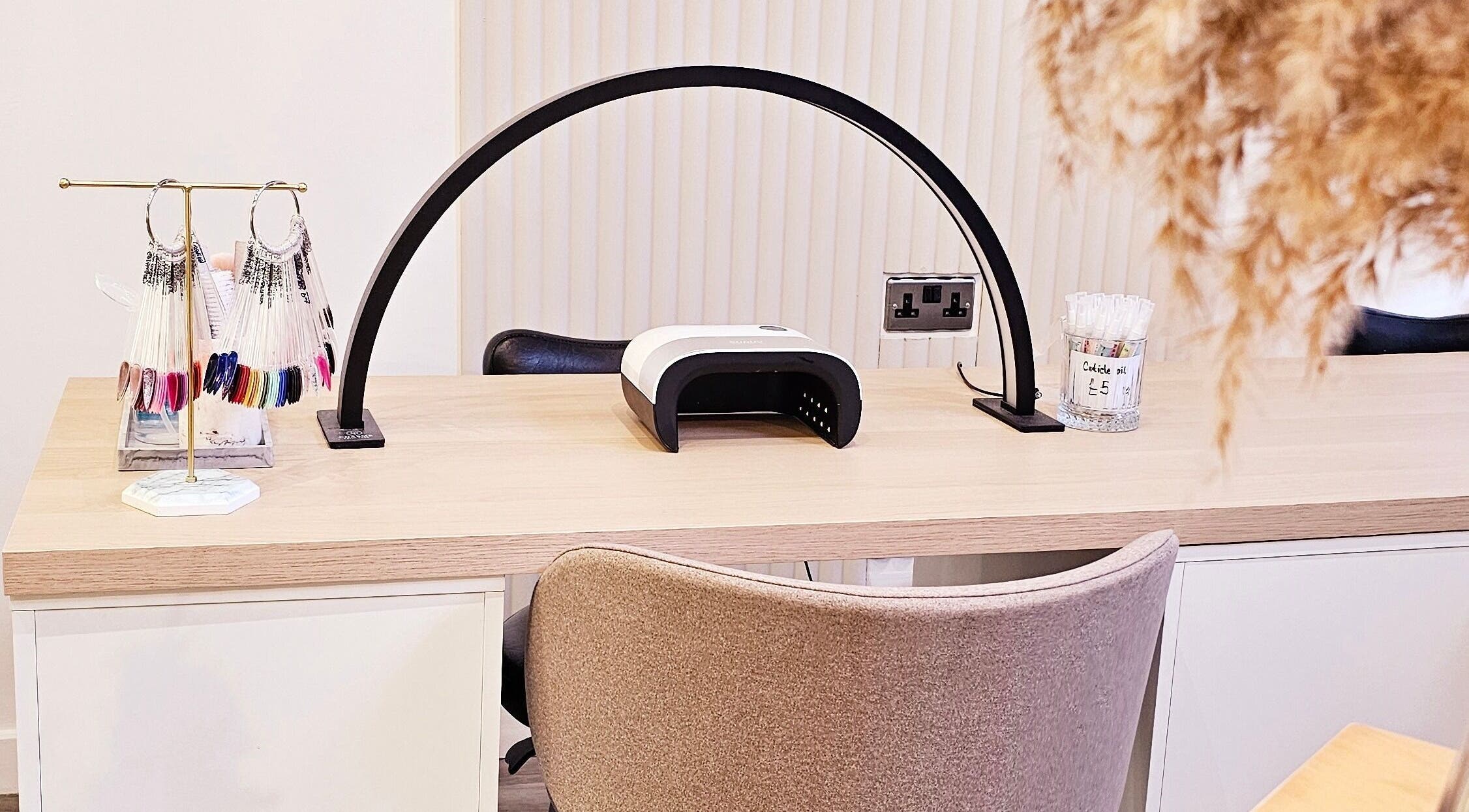 Manicure station at Tress and Bloom Ystradgynlais, Ystradgynlais, Wales, GB, featuring nail polish shades and tools.