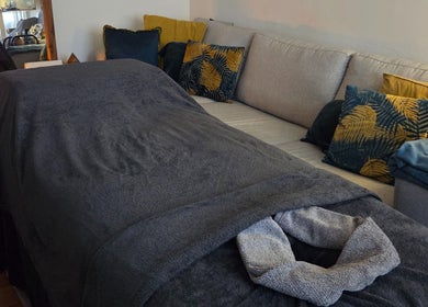 Relaxing massage area with soft blanket and cushions at JemStone Therapy, London, England, GB.