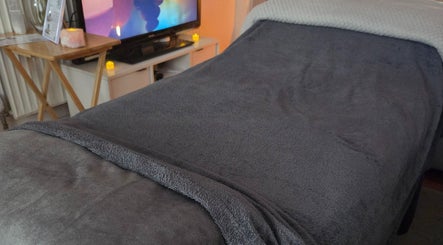Cozy therapy bed at JemStone Therapy, London, England, GB, creating a relaxing spa ambiance.