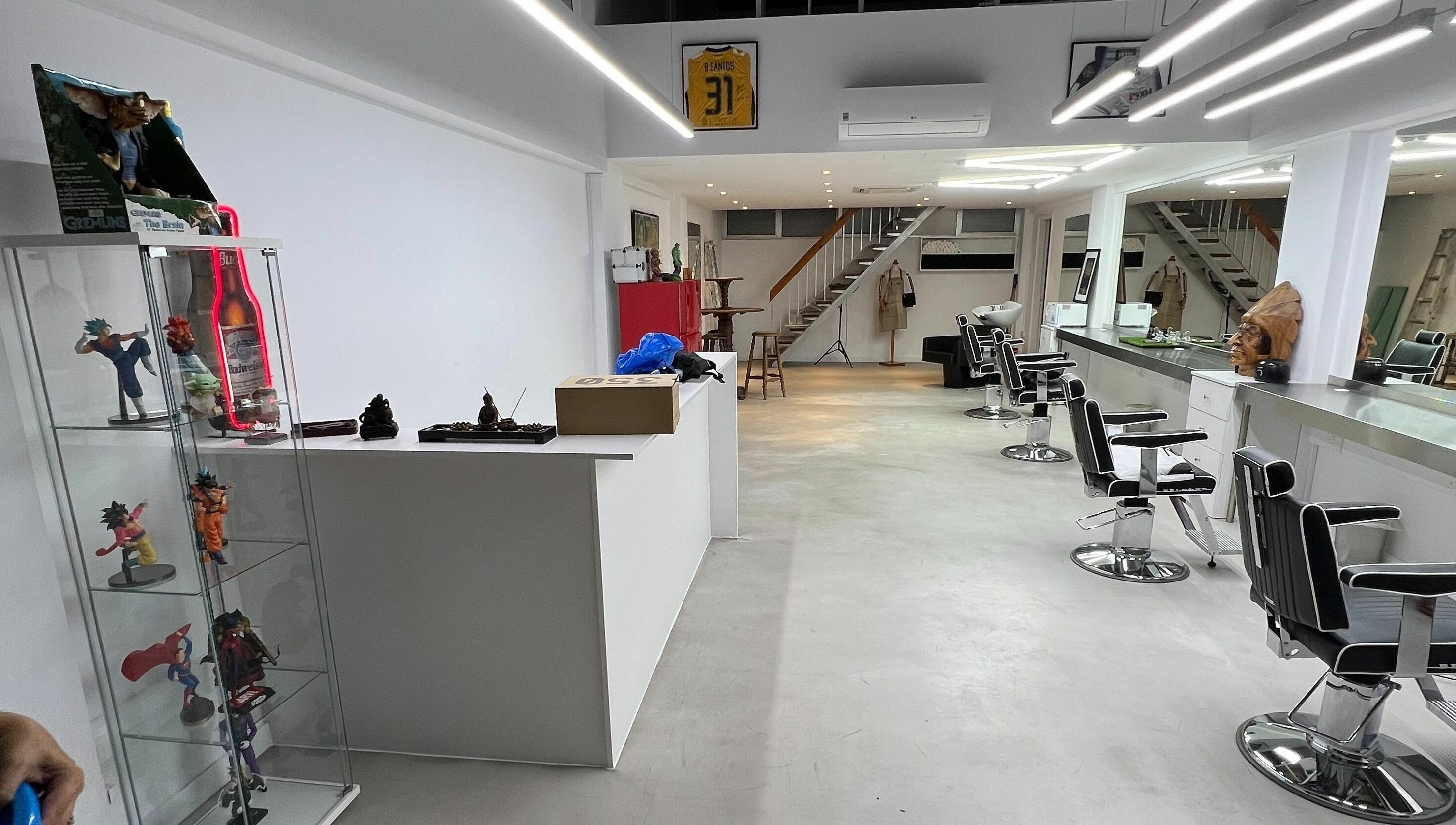 Contemporary salon interior at The House of the Butcher, Limassol, CY, showcasing sleek styling chairs and modern decor.