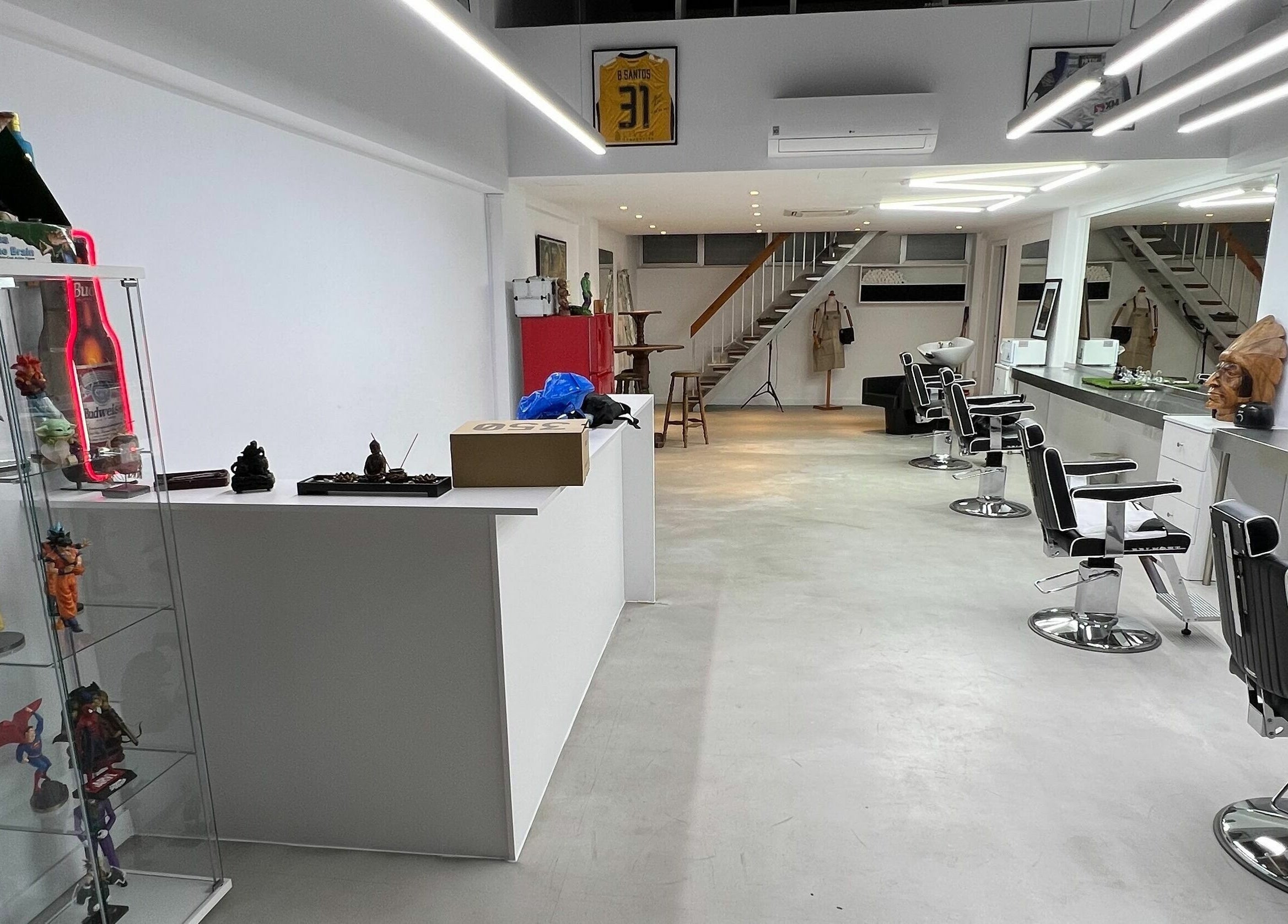 Contemporary salon interior at The House of the Butcher, Limassol, CY, showcasing sleek styling chairs and modern decor.