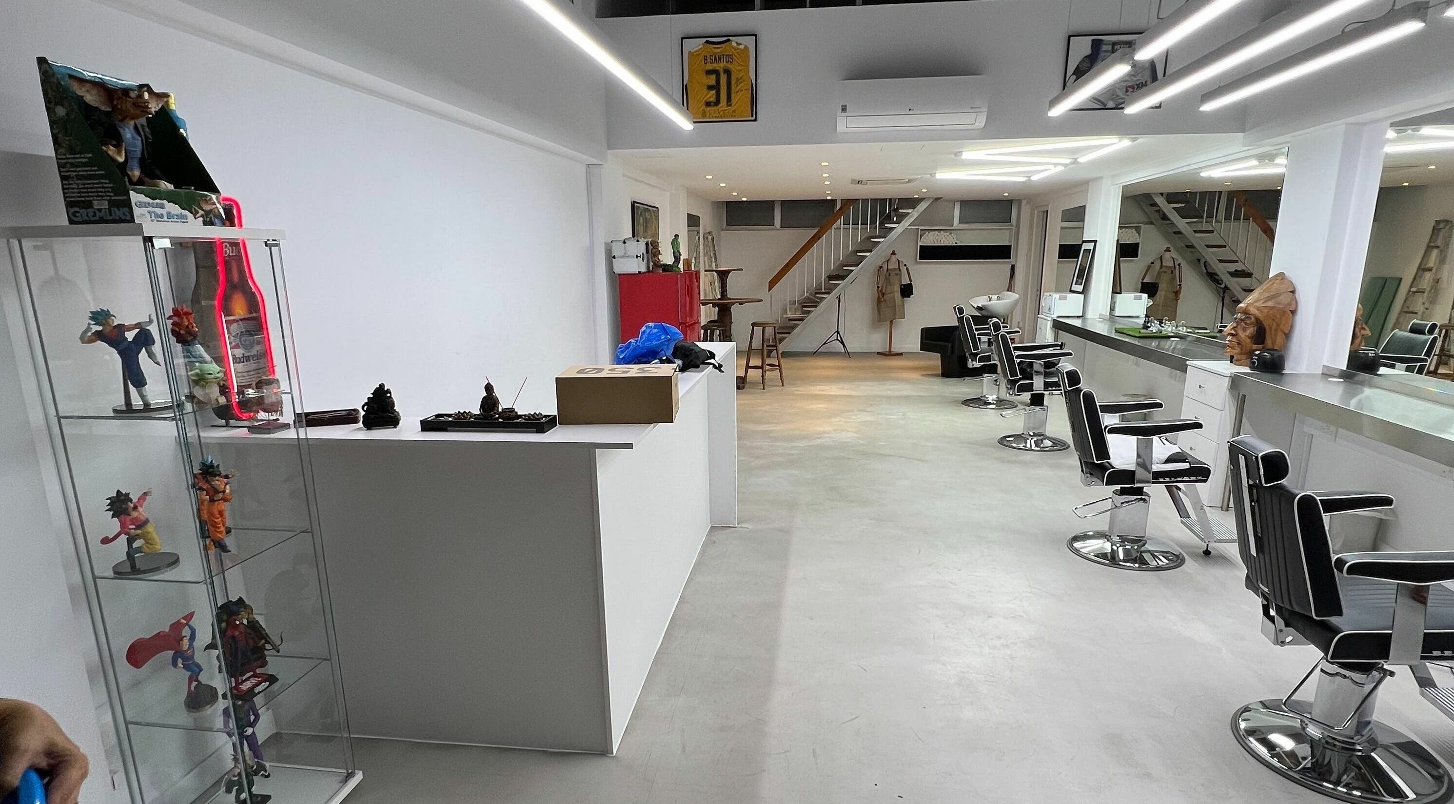 Contemporary salon interior at The House of the Butcher, Limassol, CY, showcasing sleek styling chairs and modern decor.