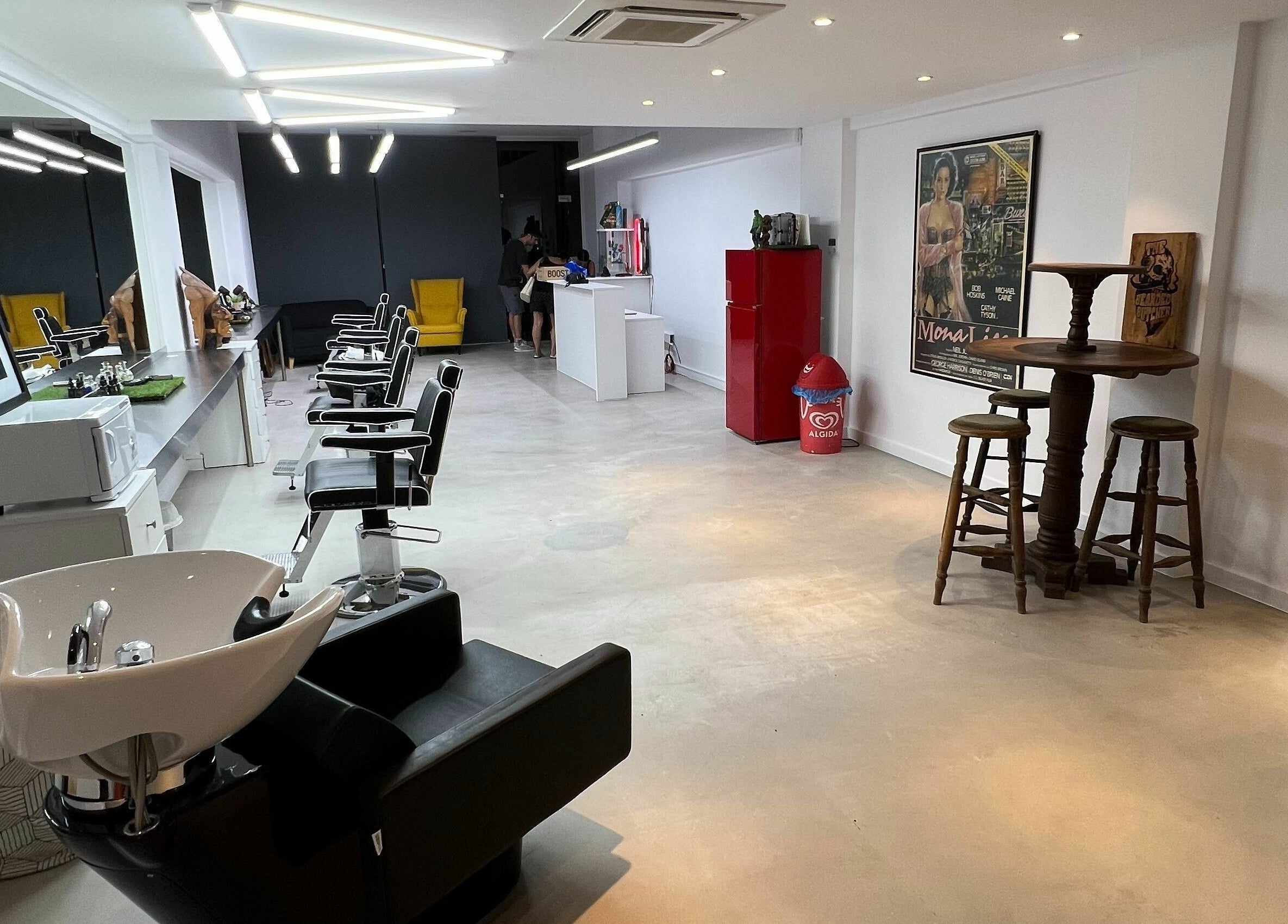 Modern salon interior at The House of the Butcher, Limassol, CY with sleek styling stations and vibrant decor.