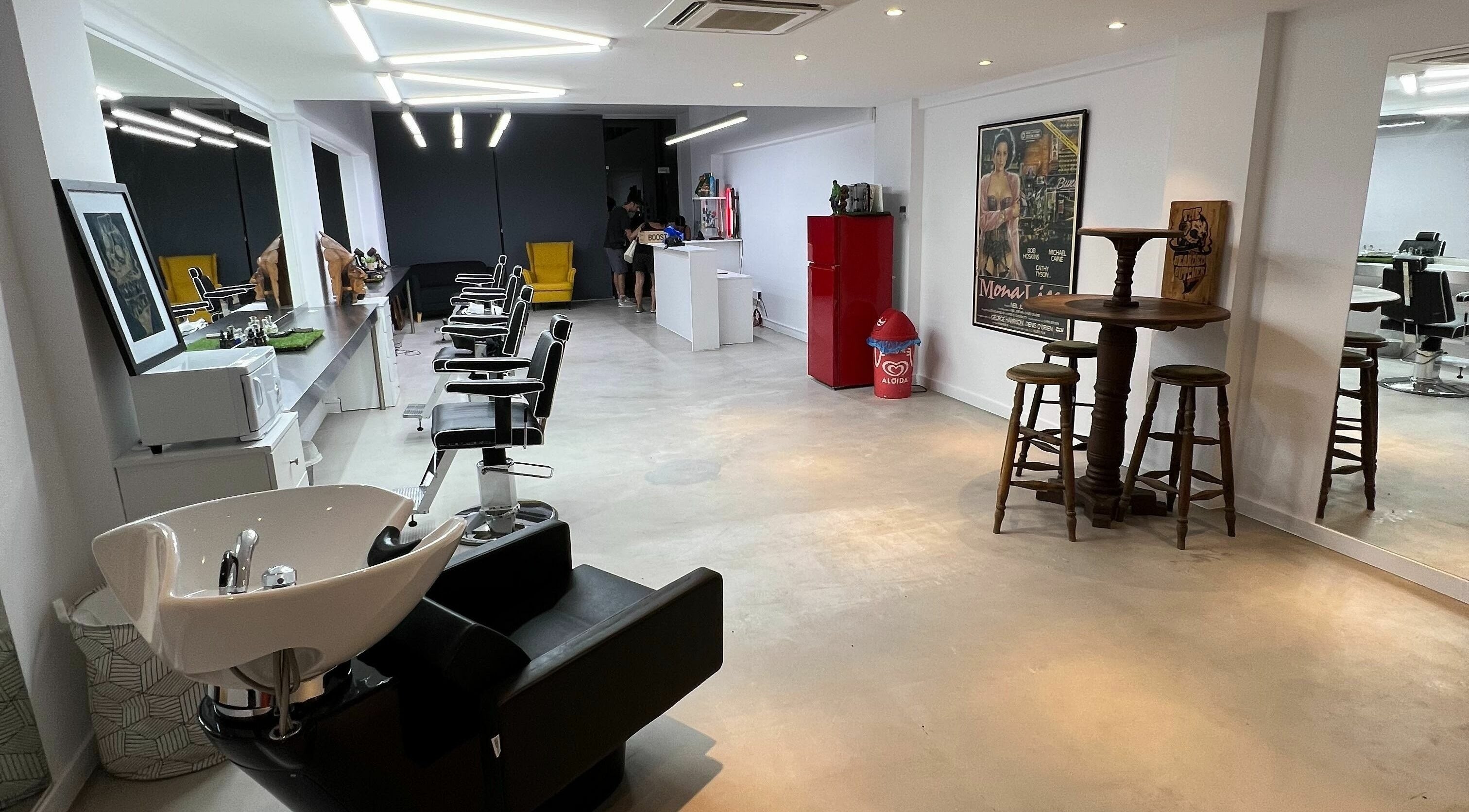 Modern salon interior at The House of the Butcher, Limassol, CY with sleek styling stations and vibrant decor.