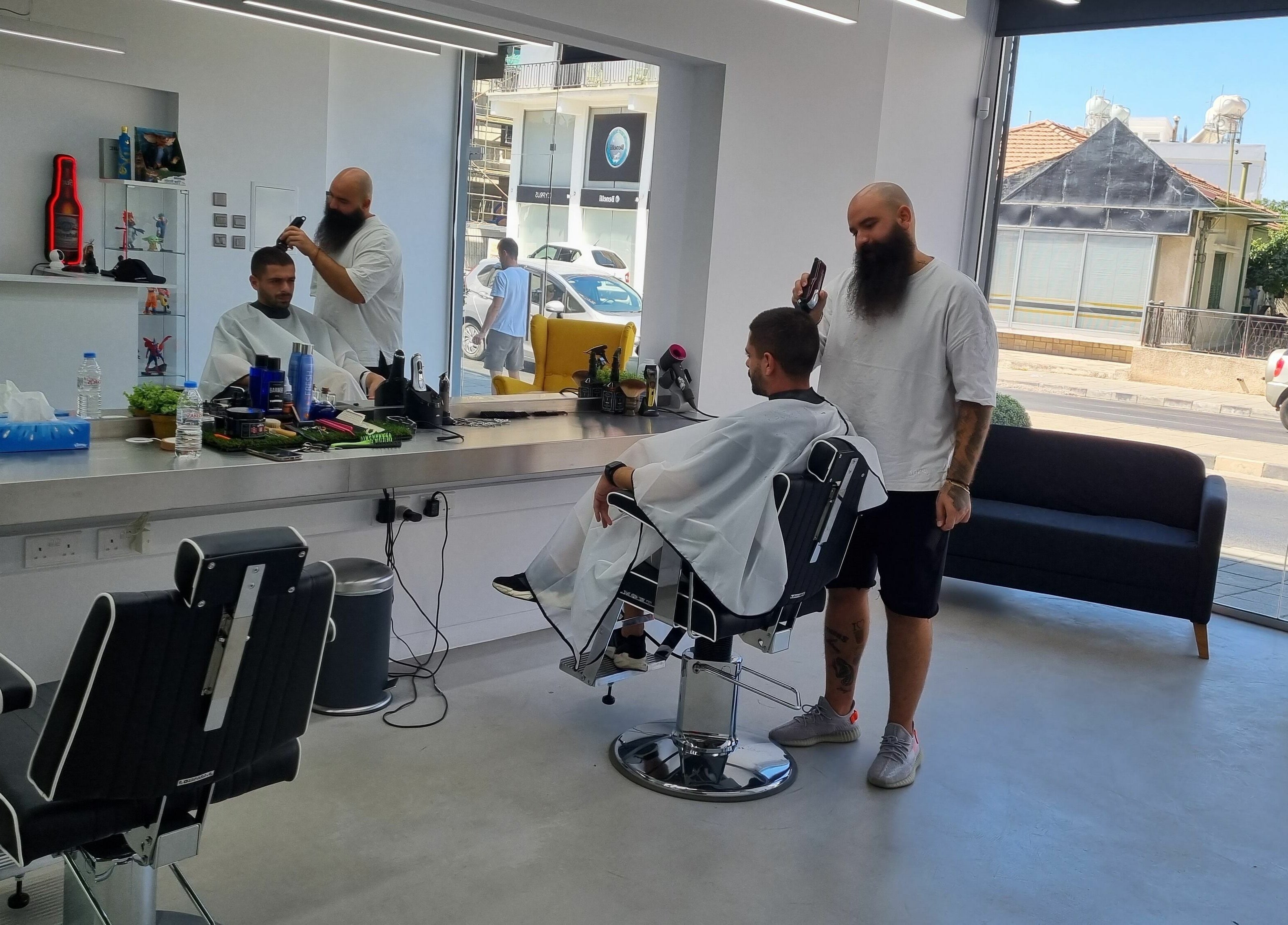 Barber at The House of the Butcher in Limassol, Limassol, CY expertly styling a client's hair.