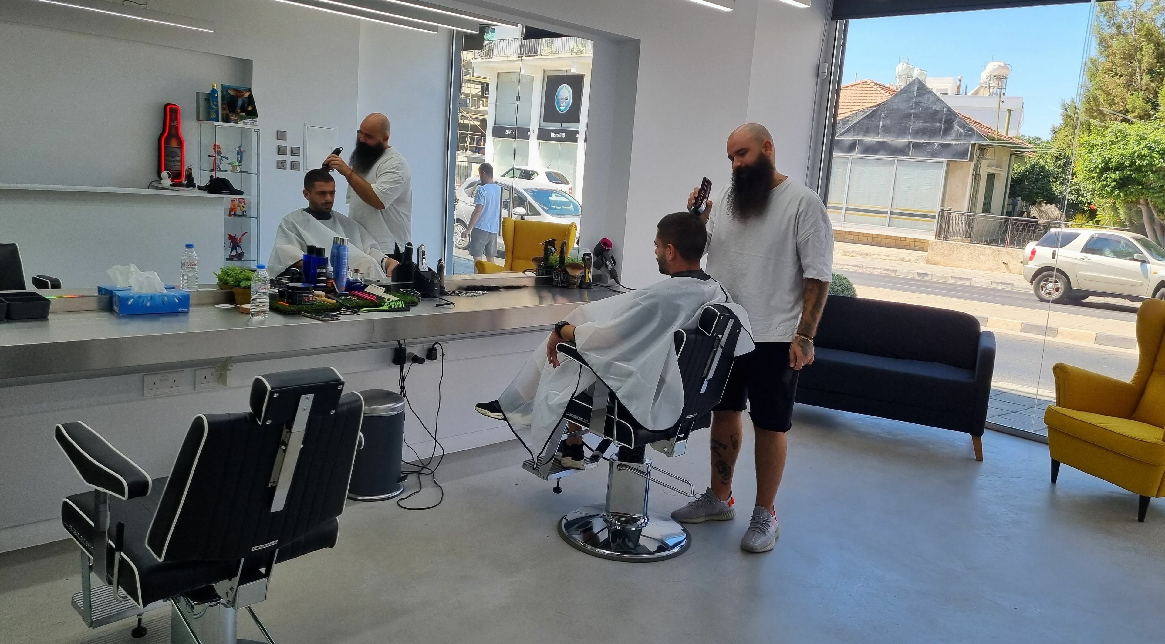 Barber at The House of the Butcher in Limassol, Limassol, CY expertly styling a client's hair.