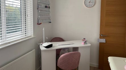 Orchid Beauty nail station in Crawley, England, GB featuring a chic manicure setup with pink chairs.