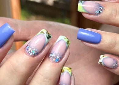 Elegant nail art at Ballerina Beauty in Leeds, England, GB featuring vibrant blue and glitter design.