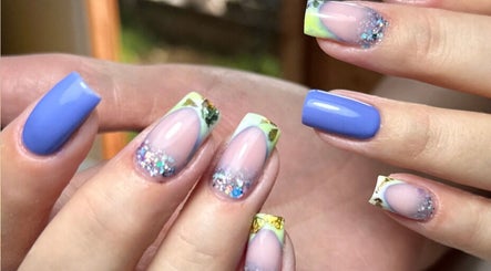 Elegant nail art at Ballerina Beauty in Leeds, England, GB featuring vibrant blue and glitter design.