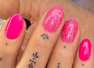 Neon pink glitter nails at Ballerina Beauty, Leeds, England, GB. Stunning manicure with charming tiny tattoos.