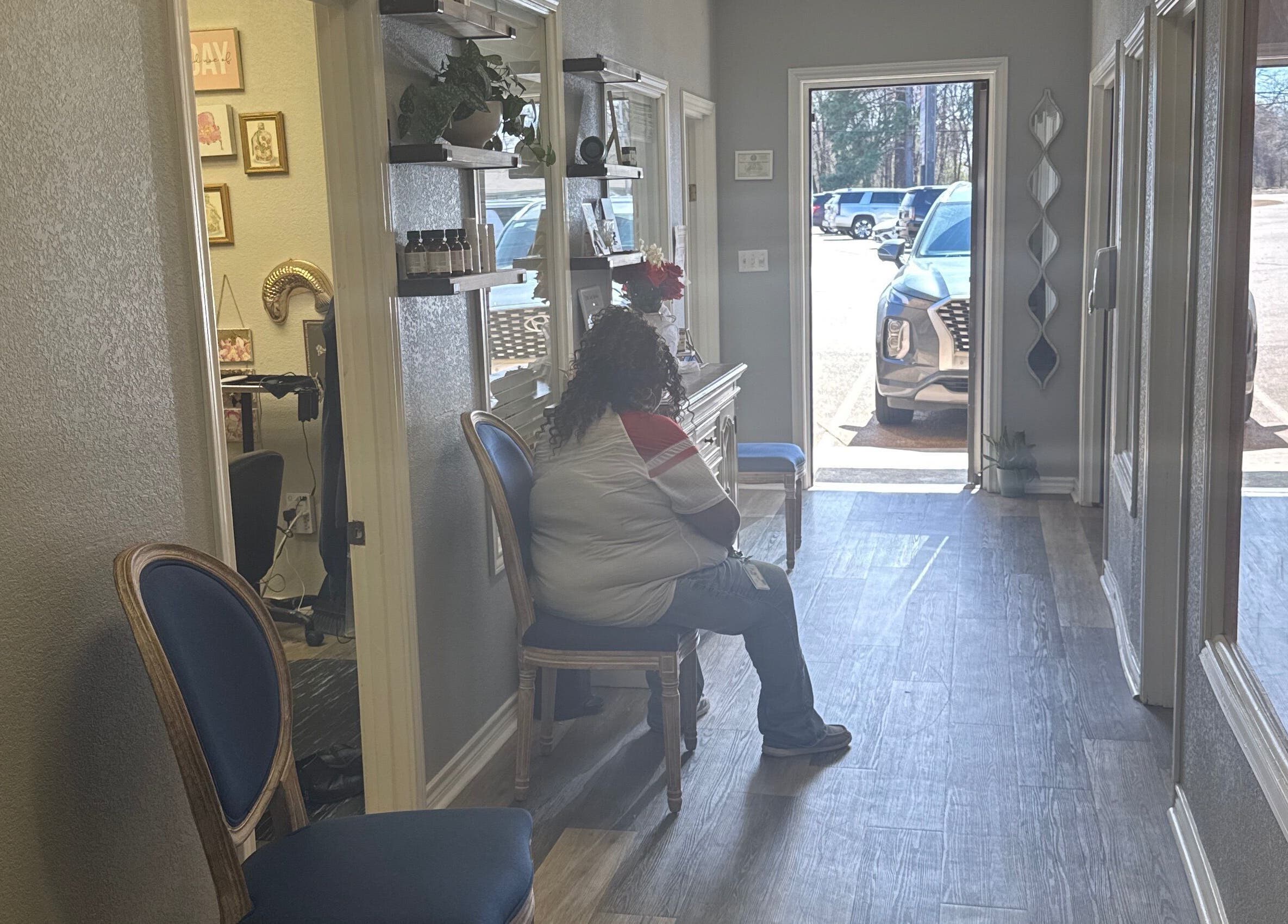 Cozy waiting area at Studio ELL.B, Texarkana, Texas, US with a seated customer and decor.