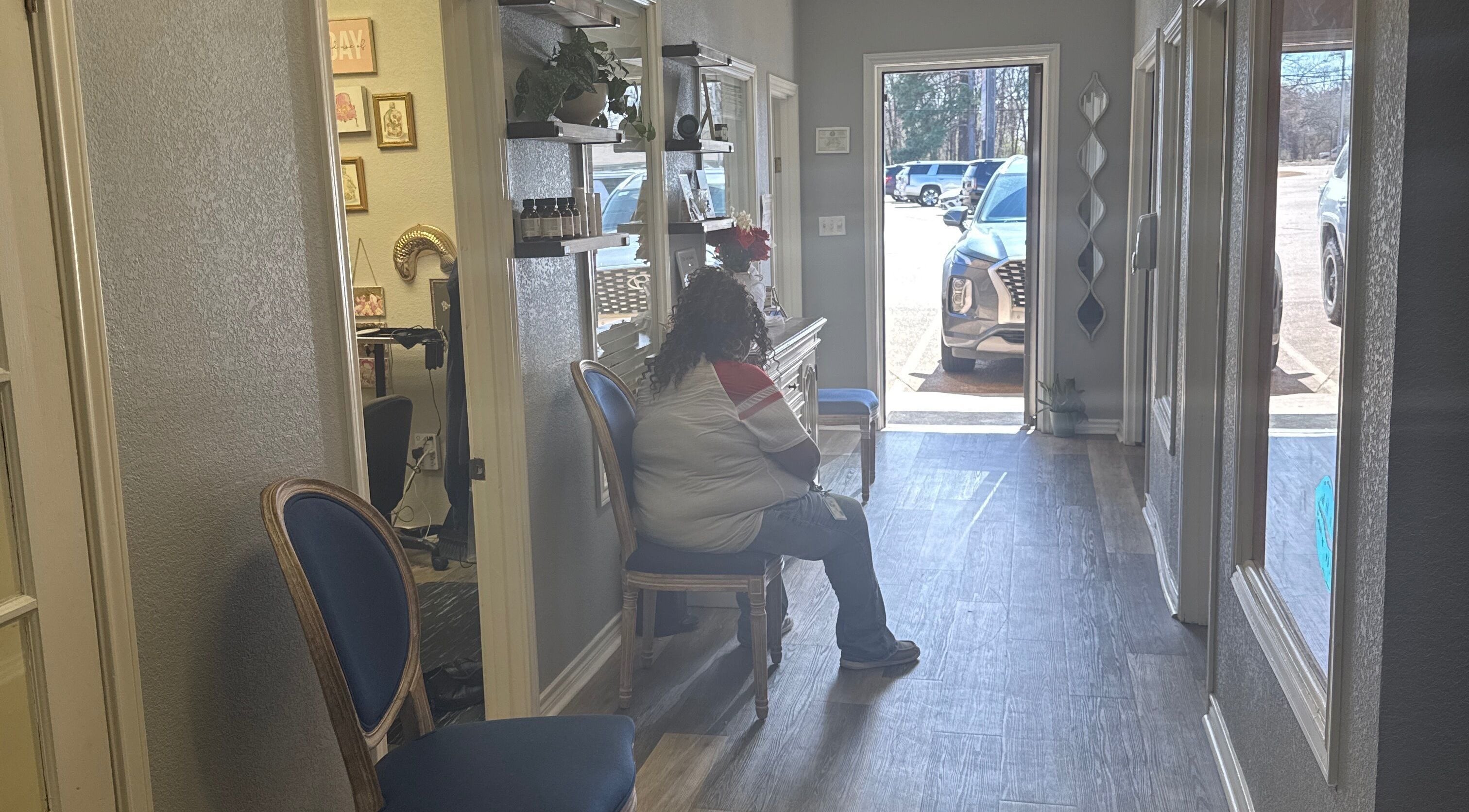 Cozy waiting area at Studio ELL.B, Texarkana, Texas, US with a seated customer and decor.