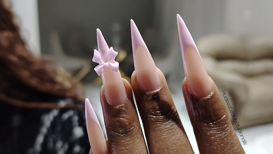 Trendy long stiletto nails with 3D pink bow at Prudeee.Beauty.Studio, Akasia, Gauteng, ZA.