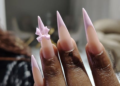 Trendy long stiletto nails with 3D pink bow at Prudeee.Beauty.Studio, Akasia, Gauteng, ZA.