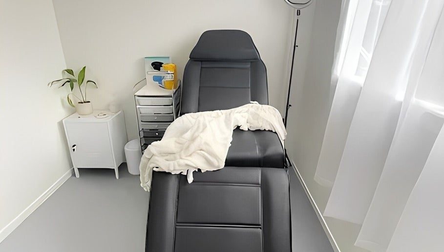 Relaxing treatment room at Aio Skin (Friday Glow), Kawakawa, Northland, NZ, with a comfortable chair and serene decor.