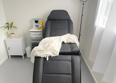 Relaxing treatment room at Aio Skin (Friday Glow), Kawakawa, Northland, NZ, with a comfortable chair and serene decor.