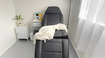 Relaxing treatment room at Aio Skin (Friday Glow), Kawakawa, Northland, NZ, with a comfortable chair and serene decor.
