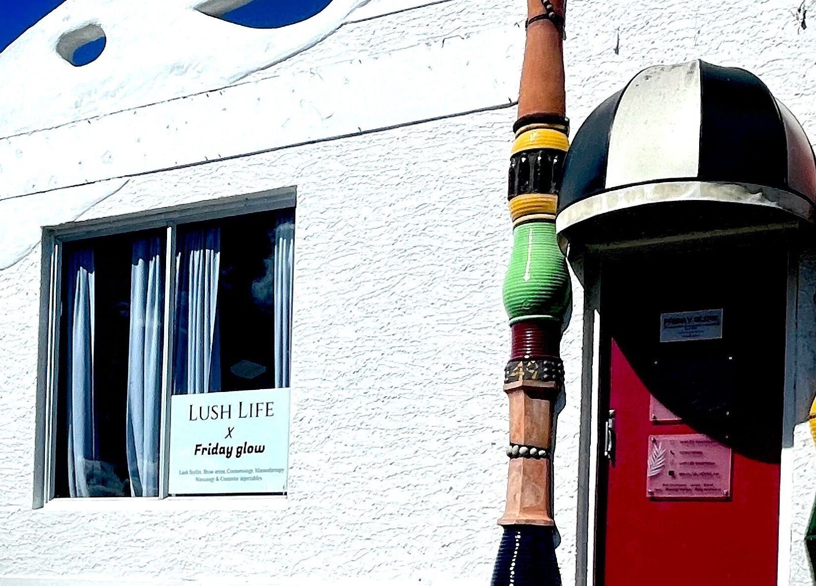 Entrance of Aio Skin (Friday Glow) in Kawakawa, Northland, NZ with colorful decor.