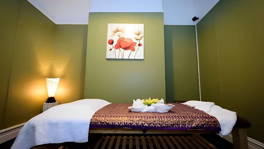 Relaxing massage room at Nina Thai & Remedial Massage, Melbourne, Victoria, AU with cozy green decor.