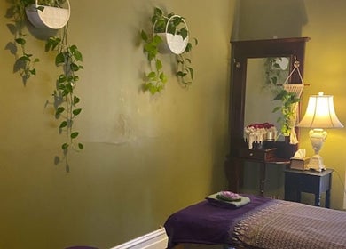 Tranquil massage room at Nina Thai & Remedial Massage, Melbourne, Victoria, AU, with soft lighting and plants.
