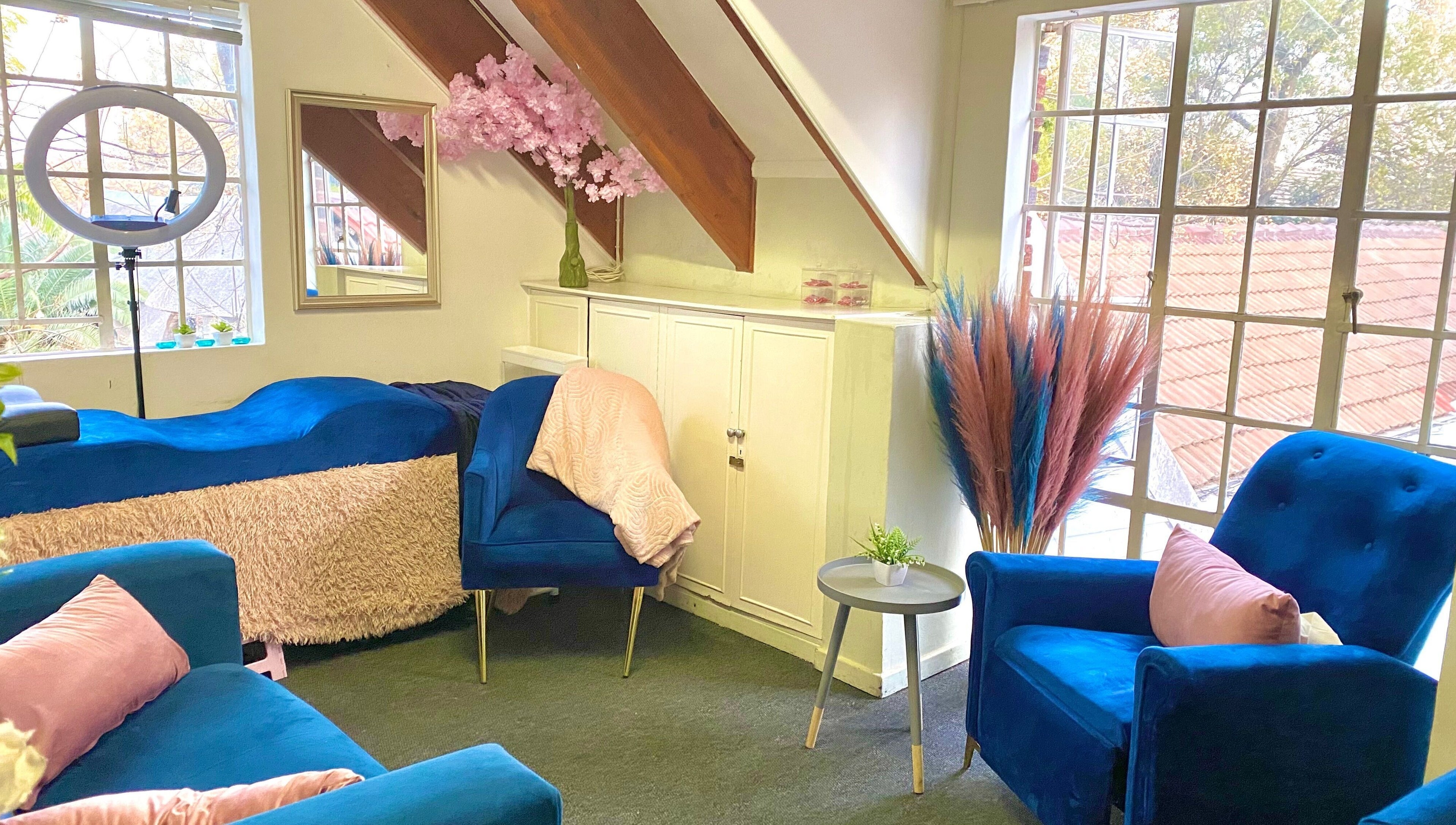 Cozy salon interior with blue chairs at GlossandGrace_BeautyAtelier, Johannesburg, Gauteng, ZA.