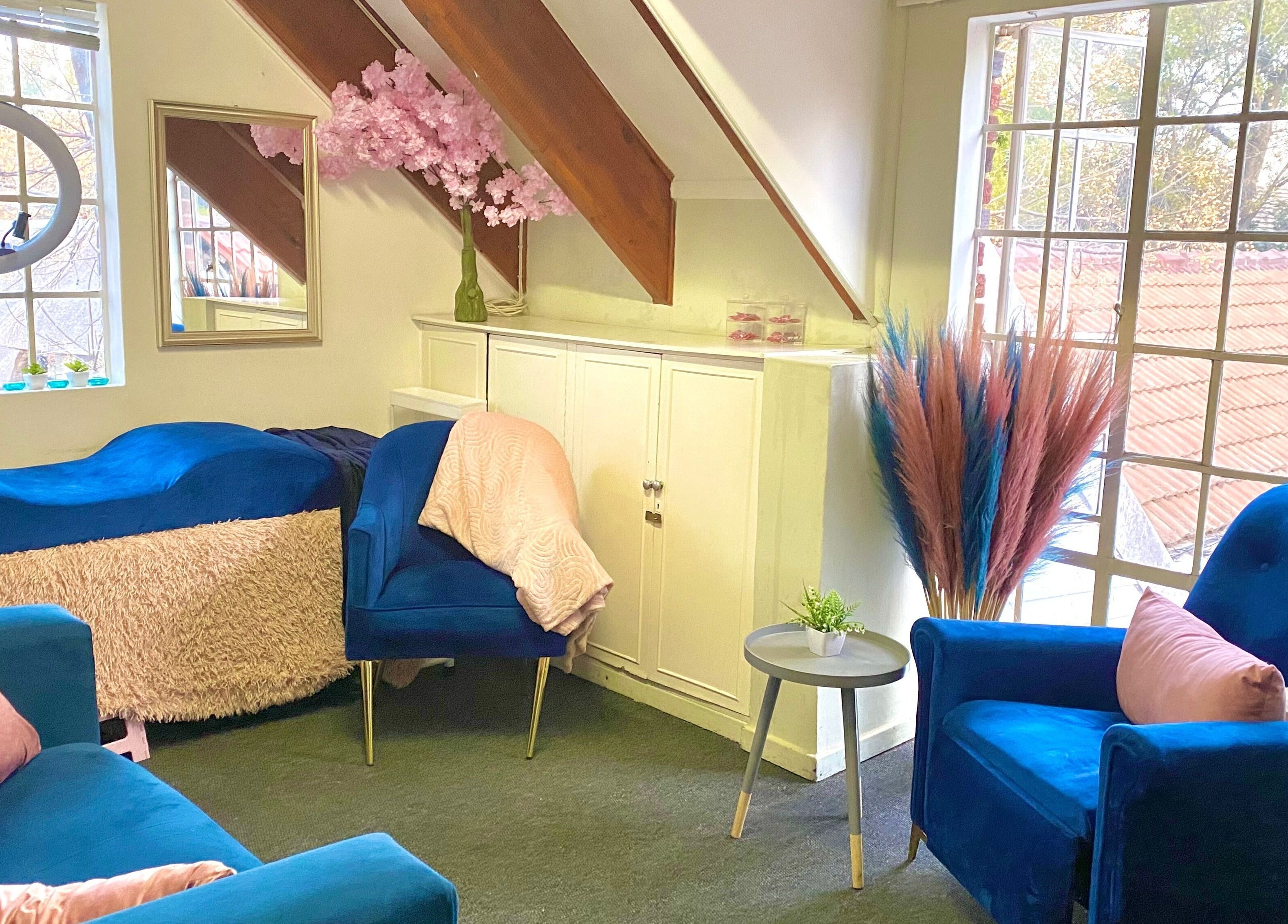 Cozy salon interior with blue chairs at GlossandGrace_BeautyAtelier, Johannesburg, Gauteng, ZA.