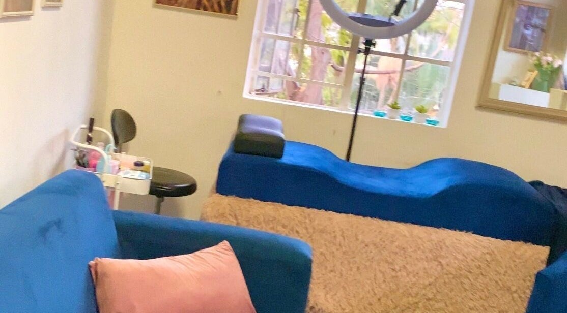 Relaxing beauty lounge at GlossandGrace_BeautyAtelier in Johannesburg, Gauteng, ZA with plush blue seating.