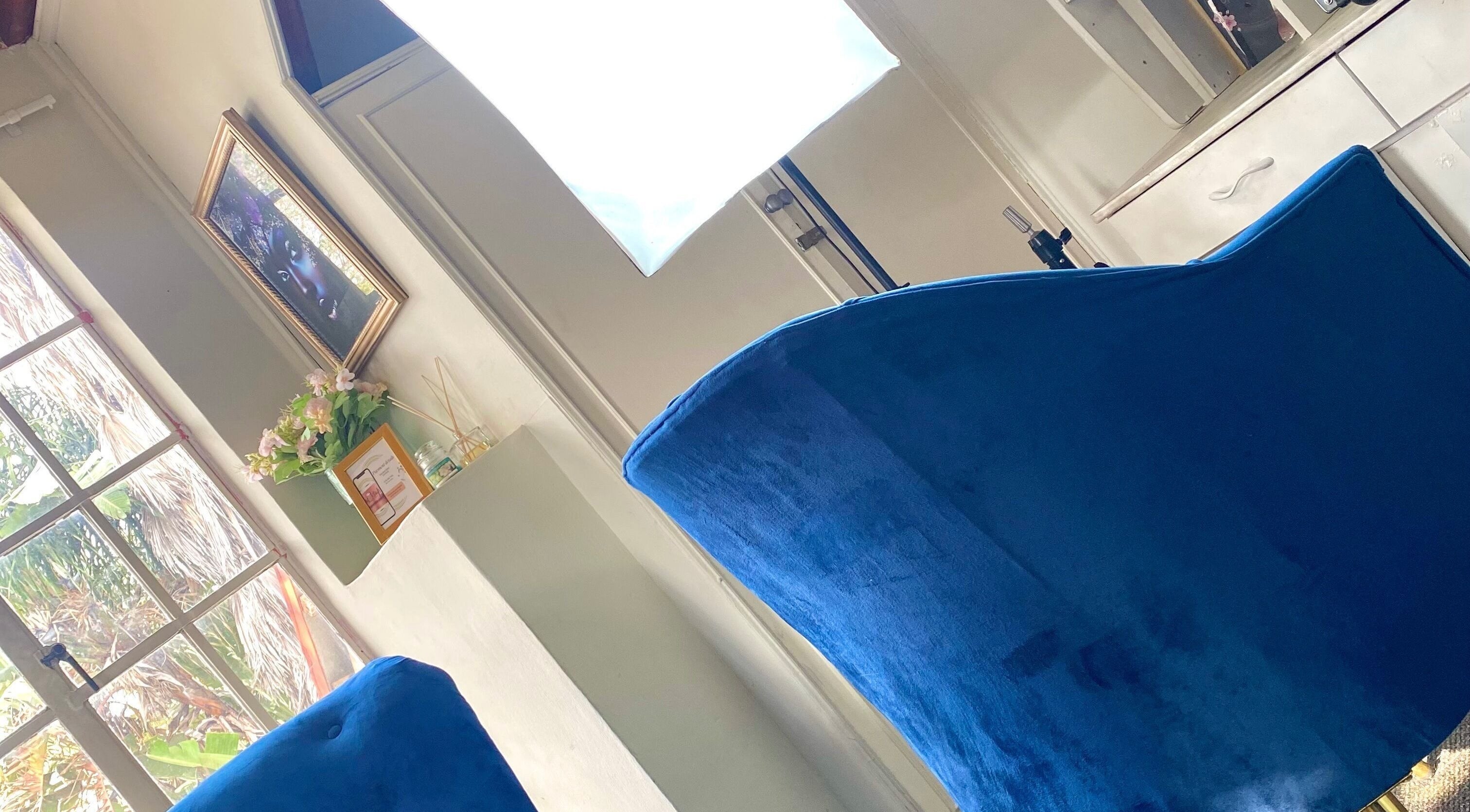 GlossandGrace_BeautyAtelier in Johannesburg, Gauteng, ZA features a serene setting with elegant blue velvet chairs.