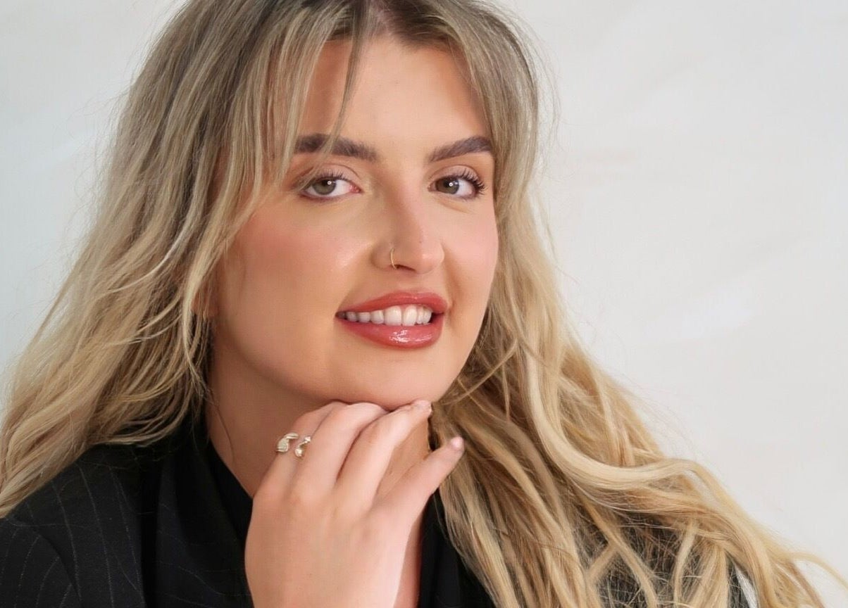 Smiling individual at Natural Aesthetics, Stoke-on-Trent, England, GB showcasing beauty services.