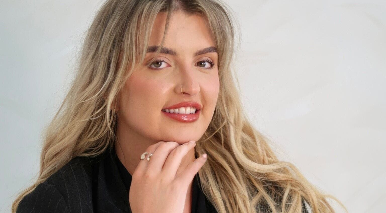 Smiling individual at Natural Aesthetics, Stoke-on-Trent, England, GB showcasing beauty services.