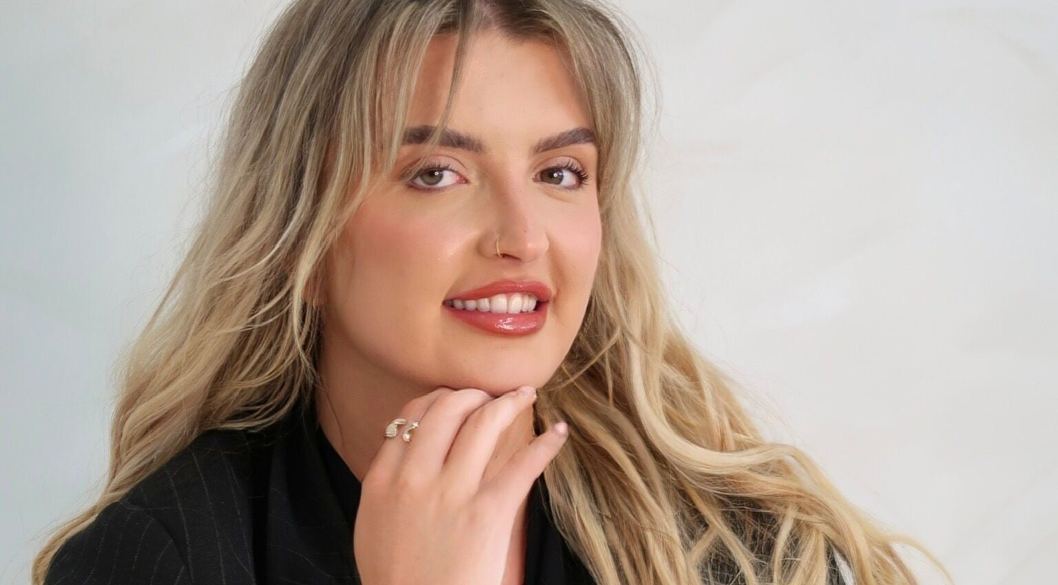 Smiling individual at Natural Aesthetics, Stoke-on-Trent, England, GB showcasing beauty services.