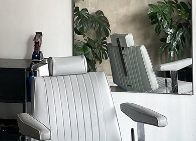 Modern salon chair at Brother Wolf St Kilda, Melbourne, Victoria, AU, with sleek design and green plants.