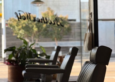 Interior view of Brother Wolf St Kilda, Melbourne, Victoria, AU, showcasing stylish salon chairs and urban decor.